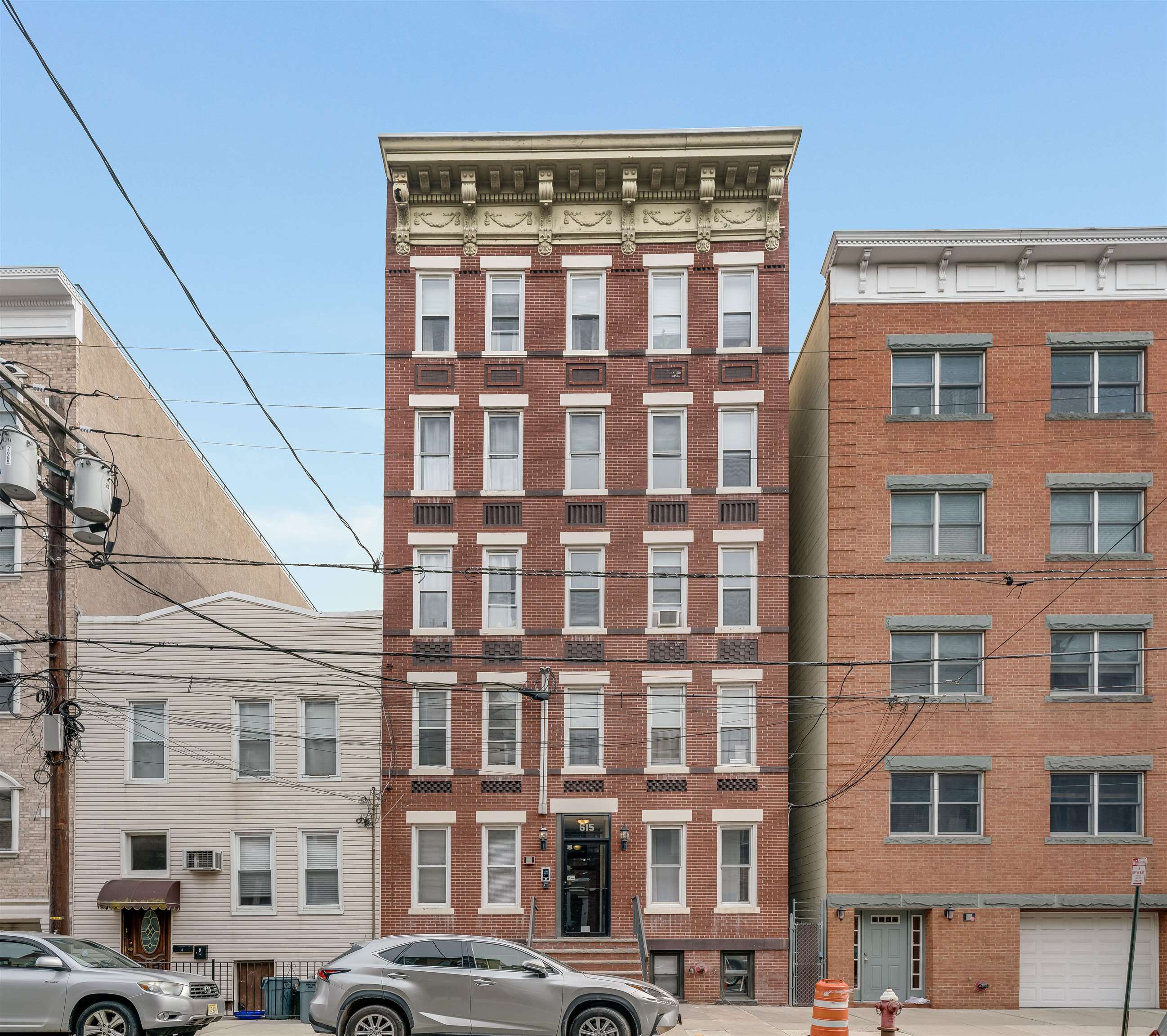 615 Monroe Street, Unit 1 Hoboken, NJ 07030 - Photo 8 of 10 a front view of a building with a lot of windows