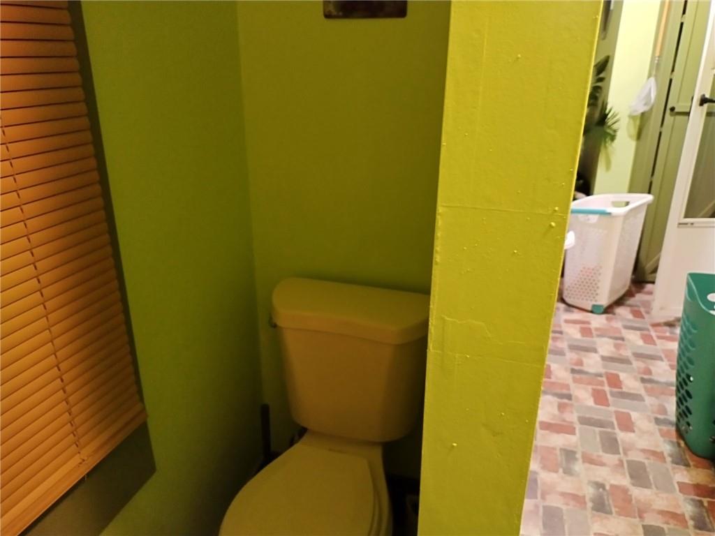 209 Gordon Avenue Calhoun, GA 30701 - Photo 17 of 30 a bathroom with a toilet and a sink