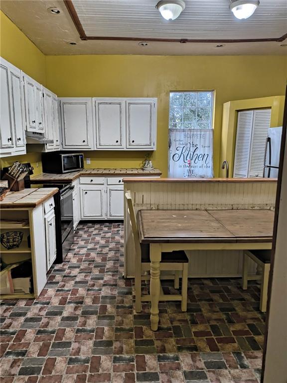 209 Gordon Avenue Calhoun, GA 30701 - Photo 7 of 30 a kitchen with a sink a stove and cabinets