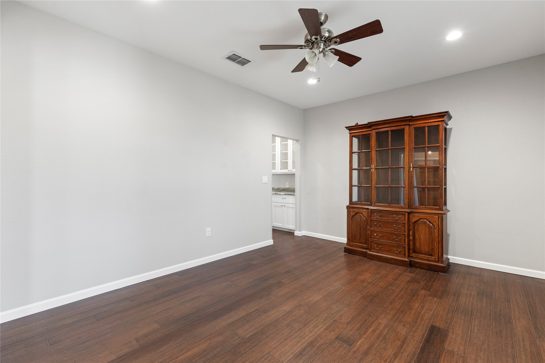 1293 Pioneer Road Seguin, TX 78155 - Photo 23 of 40 Rich hardwood floors complement light walls, creating a versatile space with recessed lighting.