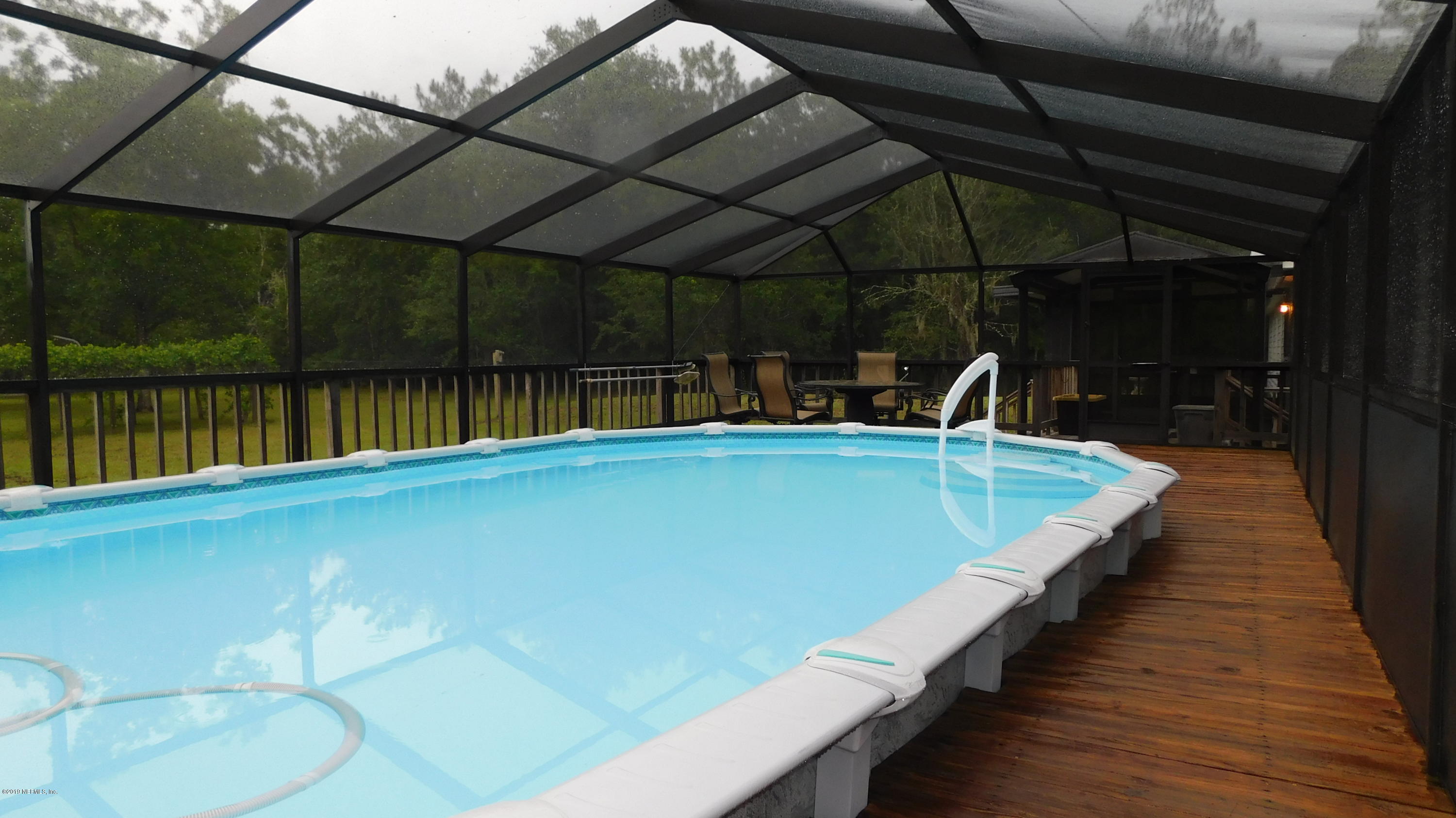 4144 Bronco Road Middleburg, FL 32068 - Photo 29 of 66 a view of a swimming pool with a patio