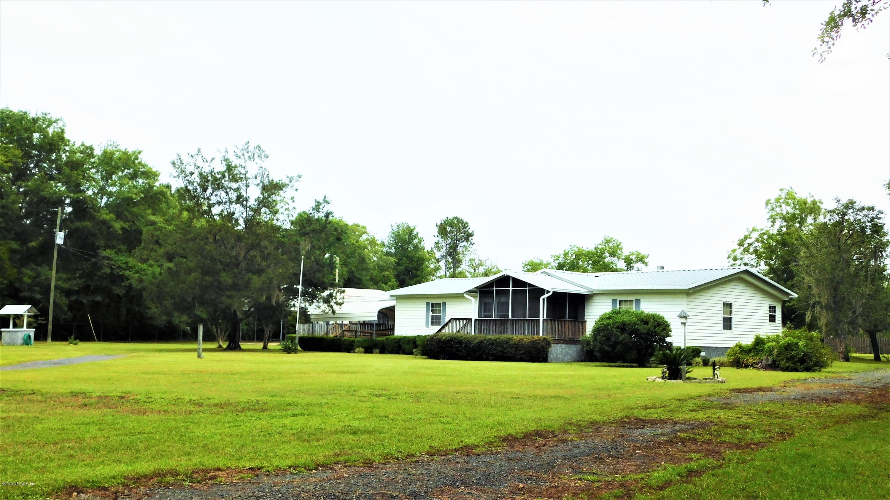 4144 Bronco Road Middleburg, FL 32068 - Photo 54 of 66 a front view of a house with a yard and trees