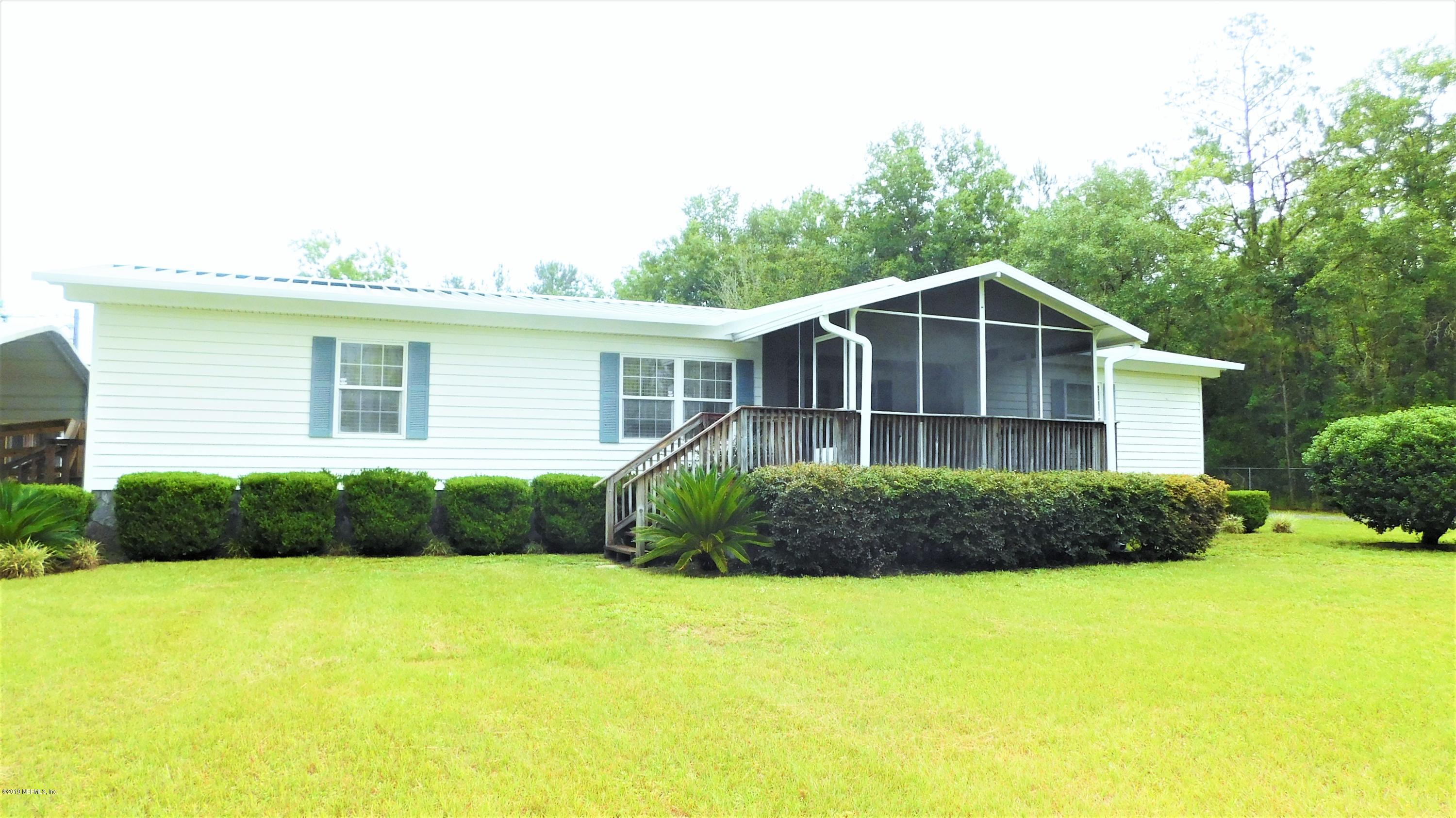 4144 Bronco Road Middleburg, FL 32068 - Photo 56 of 66 a front view of a house with garden