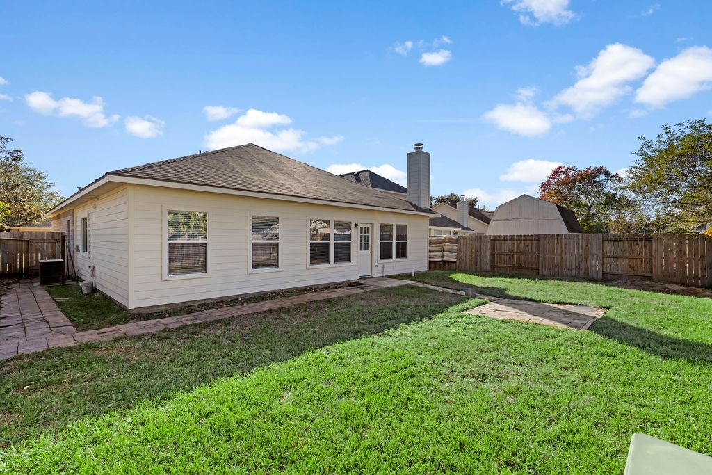 32202 Anne Lane Pinehurst, TX 77362 - Photo 11 of 11 a view of a house with yard and a garden