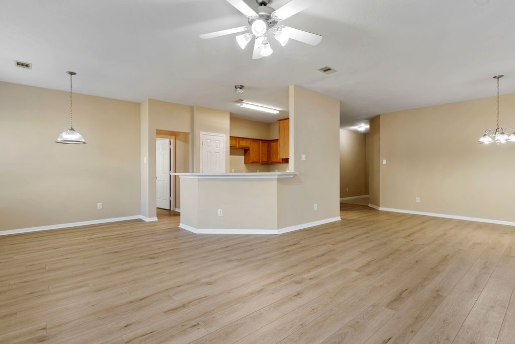 32202 Anne Lane Pinehurst, TX 77362 - Photo 3 of 11 a view of a livingroom with a ceiling fan window and wooden floor