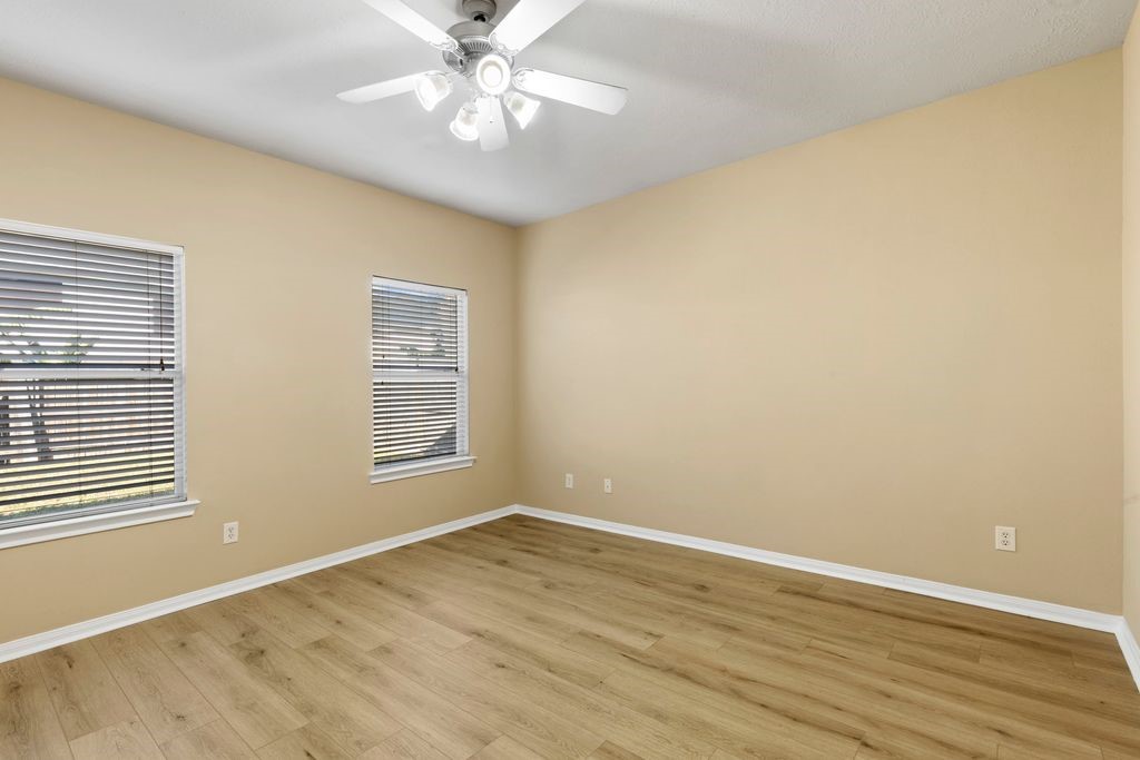 32202 Anne Lane Pinehurst, TX 77362 - Photo 5 of 11 a view of an empty room with wooden floor and a window