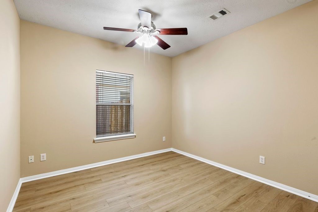 32202 Anne Lane Pinehurst, TX 77362 - Photo 8 of 11 a view of an empty room with wooden floor and a window