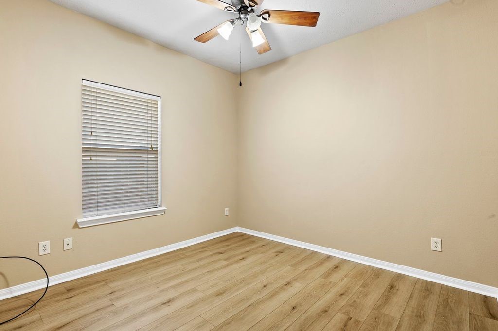 32202 Anne Lane Pinehurst, TX 77362 - Photo 9 of 11 wooden floor in an empty room with a window