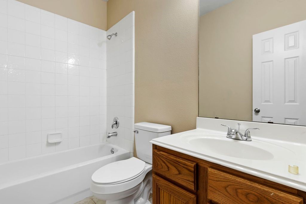 32202 Anne Lane Pinehurst, TX 77362 - Photo 10 of 11 a bathroom with a sink a toilet and shower