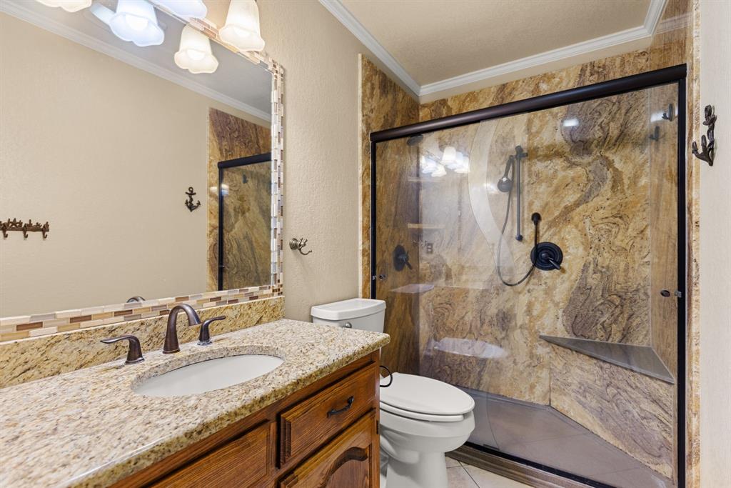 13539 Chapel Road Lorena, TX 76655 - Photo 21 of 37 Walk-in shower with natural stone-look wall panels and a built-in bench