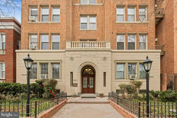 front view of a brick house with large windows