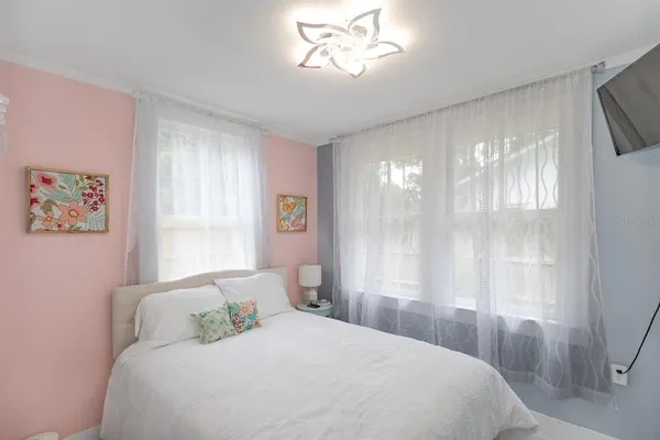 a bedroom with a bed and a chandelier