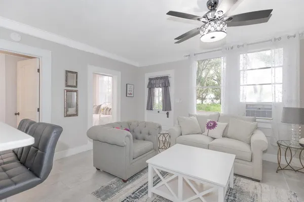 a living room with furniture and a large window