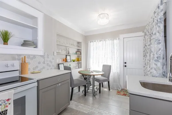 a kitchen with a sink cabinets and window