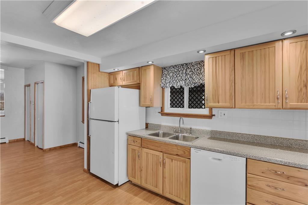 621 Bridge Irwin Pa Irwin, PA 15642 - Photo 11 of 31 a kitchen with a refrigerator sink and cabinets
