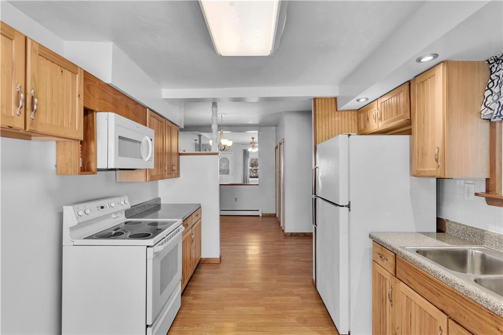 621 Bridge Irwin Pa Irwin, PA 15642 - Photo 12 of 31 a kitchen with a sink a refrigerator a stove and cabinets