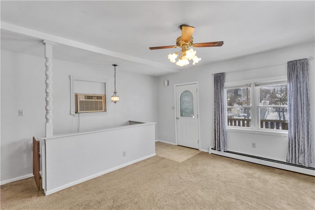 621 Bridge Irwin Pa Irwin, PA 15642 - Photo 4 of 31 a view of a big room with chandelier fan and windows