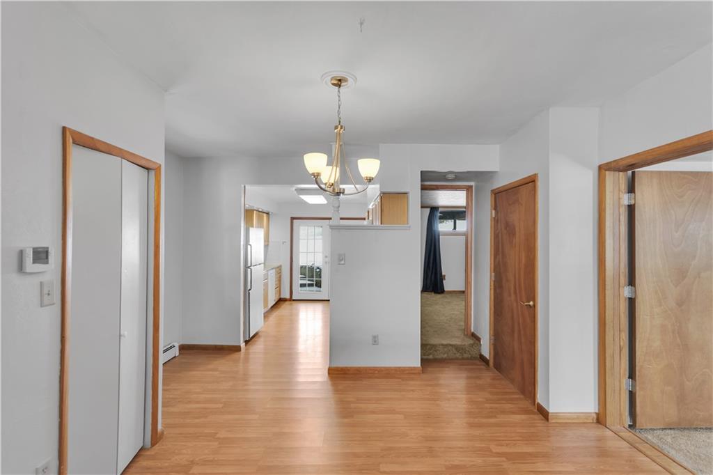 621 Bridge Irwin Pa Irwin, PA 15642 - Photo 6 of 31 a view of a hallway with wooden floor and chandelier