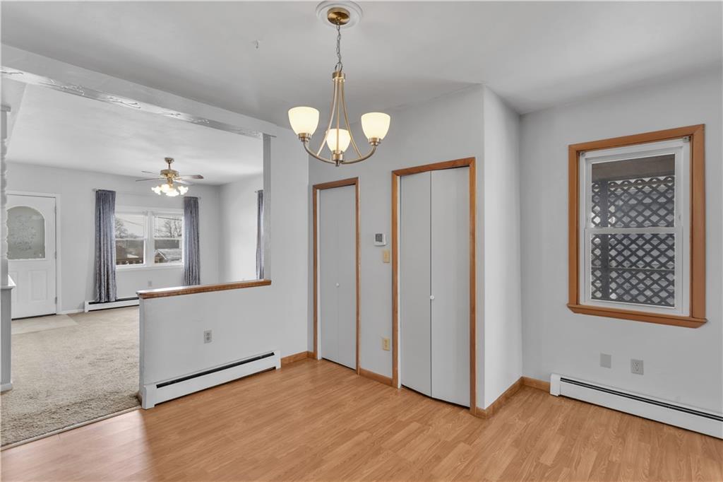 621 Bridge Irwin Pa Irwin, PA 15642 - Photo 7 of 31 a view of an empty room with window wooden floor and a kitchen