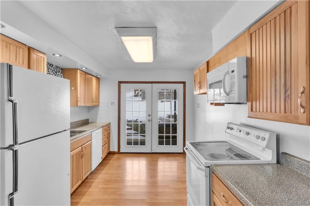 621 Bridge Irwin Pa Irwin, PA 15642 - Photo 9 of 31 a kitchen with granite countertop stainless steel appliances a refrigerator a sink and white cabinets
