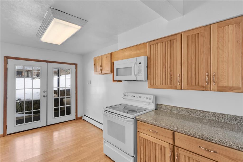 621 Bridge Irwin Pa Irwin, PA 15642 - Photo 10 of 31 a kitchen with a stove cabinets and a wooden floor