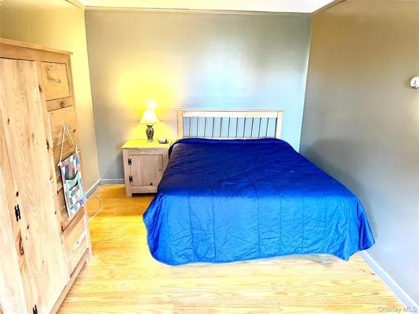 a bed sitting in a bedroom next to a window