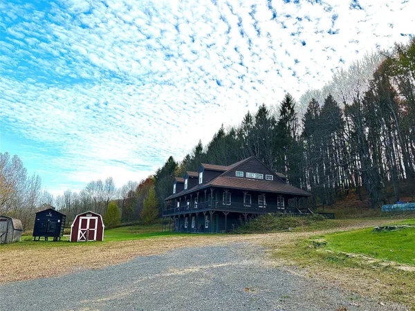 a view of a house with backyard and sitting area