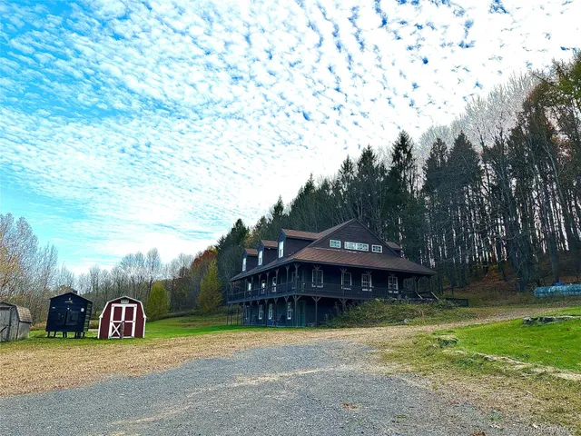a view of a house with backyard and sitting area