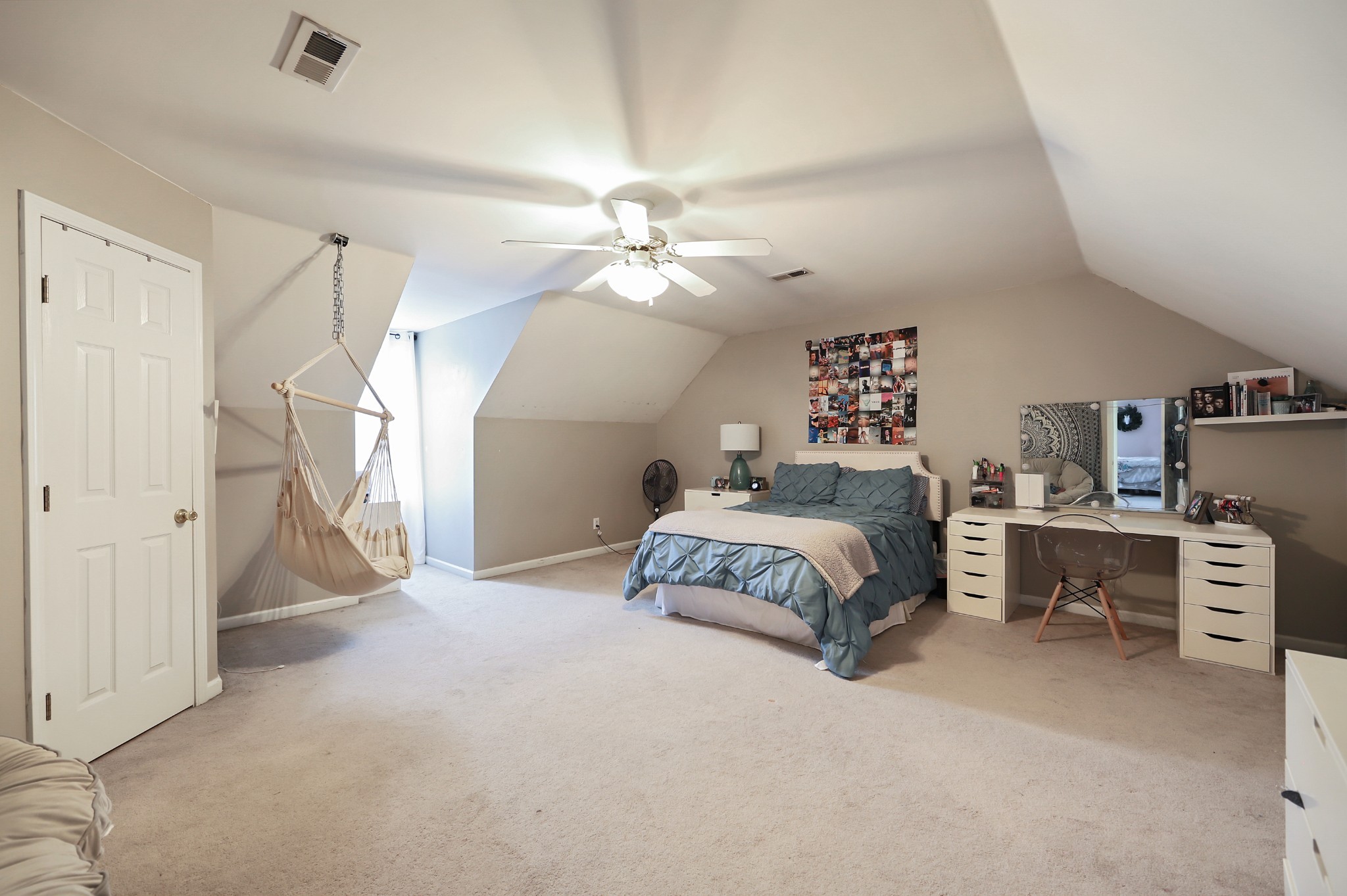 1400 Camp Ravine Road Burns, TN 37029 - Photo 17 of 40 a spacious bedroom with a bed a dresser and a chandelier