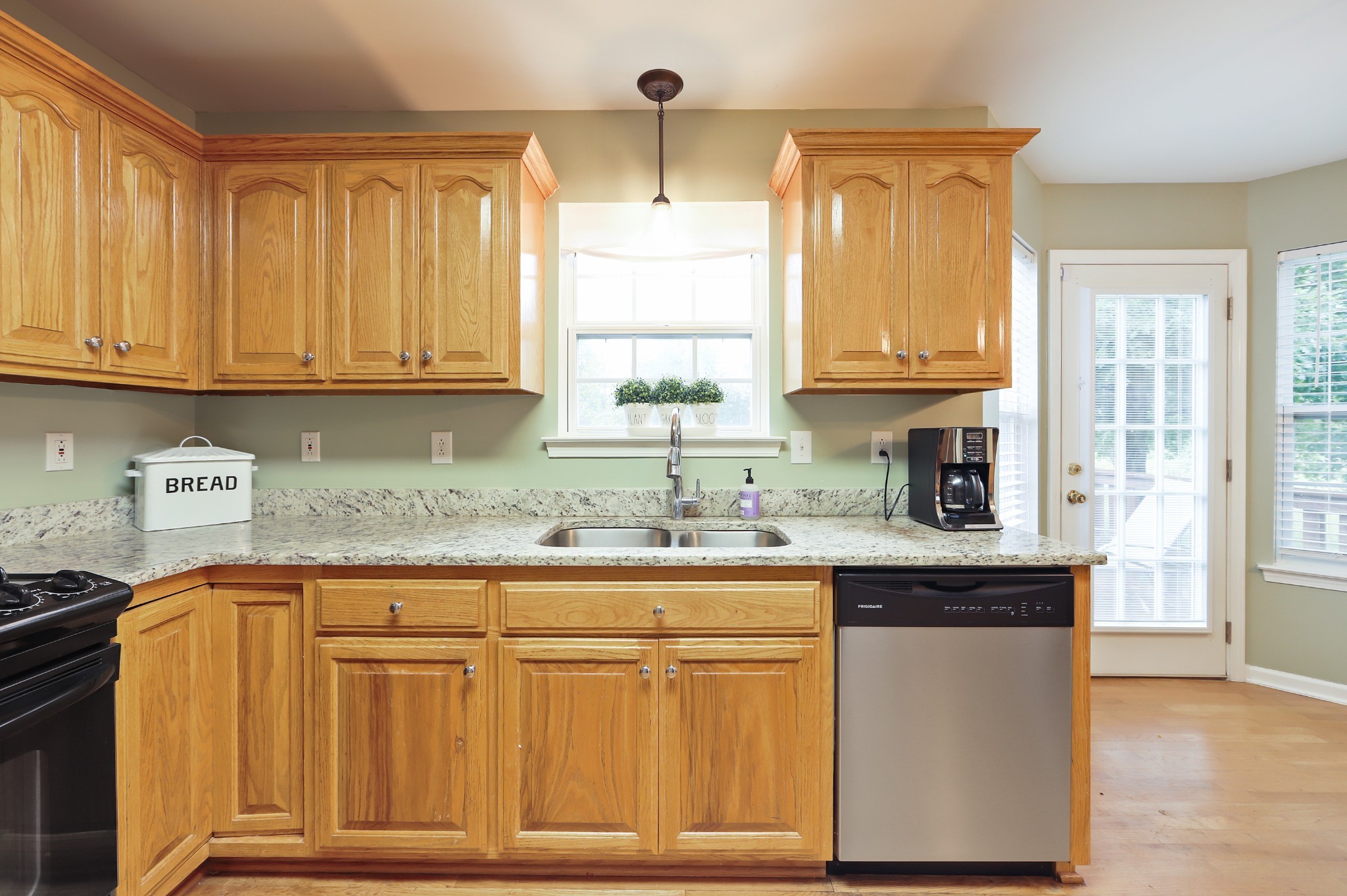 1400 Camp Ravine Road Burns, TN 37029 - Photo 27 of 40 a kitchen with granite countertop a sink cabinets and window