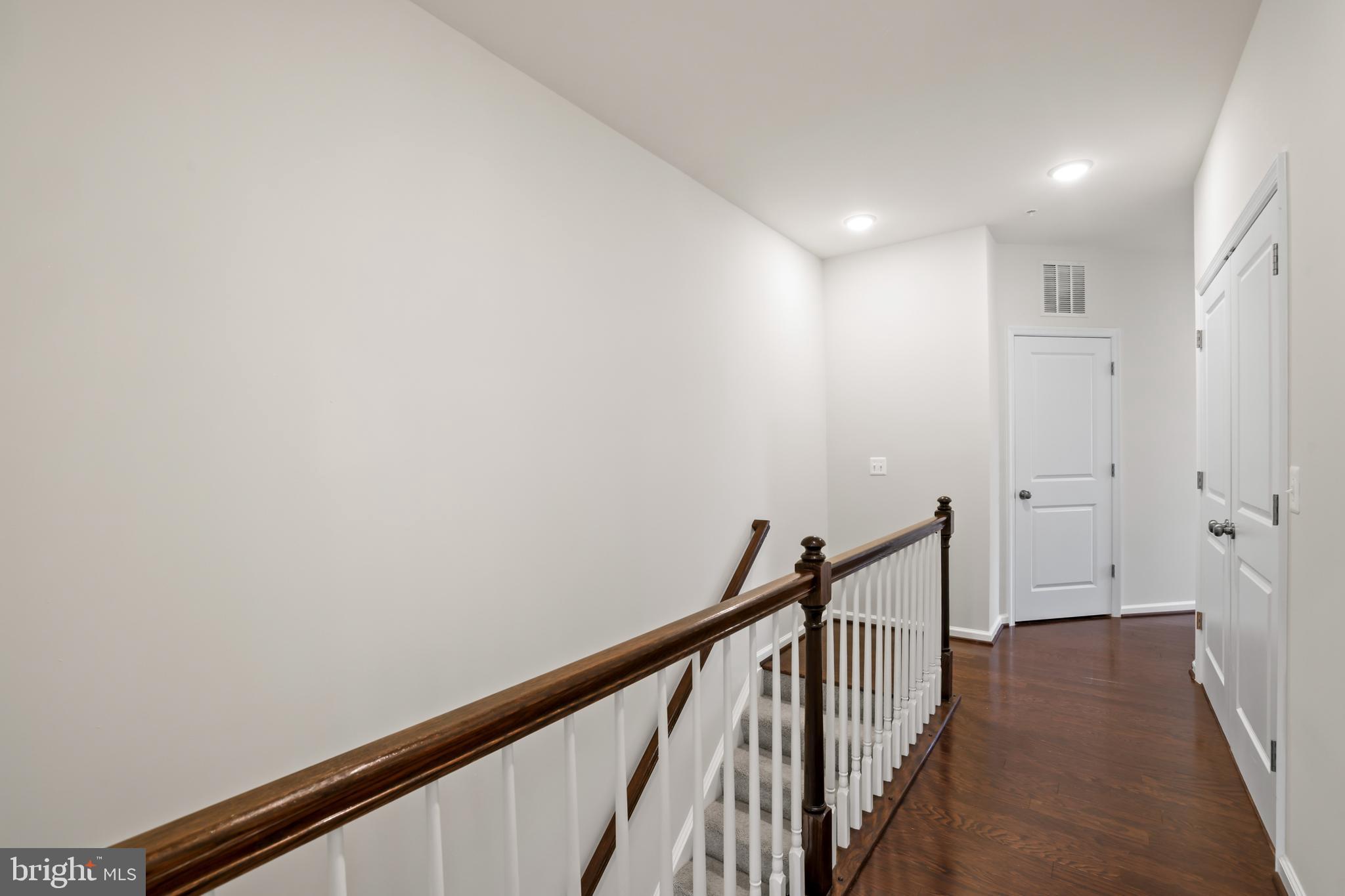 1102 Ribbon Limestone Terrace Southeast Leesburg, VA 20175 - Photo 27 of 51 a view of a hallway with wooden floor and staircase