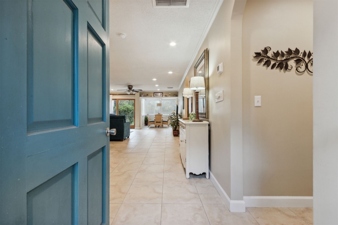 3327 Sea Marsh Road, Unit 3327 Fernandina Beach, FL 32034 - Photo 2 of 33 a view of a hallway with dining area and chandelier