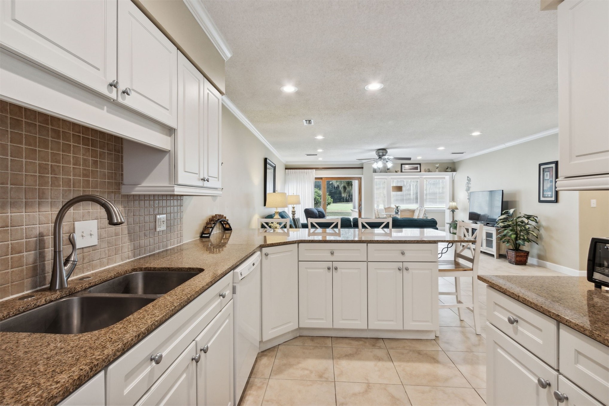 3327 Sea Marsh Road, Unit 3327 Fernandina Beach, FL 32034 - Photo 8 of 39 a kitchen with white cabinets a sink and dishwasher