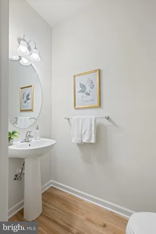 a kitchen with a dining table chairs and white cabinets