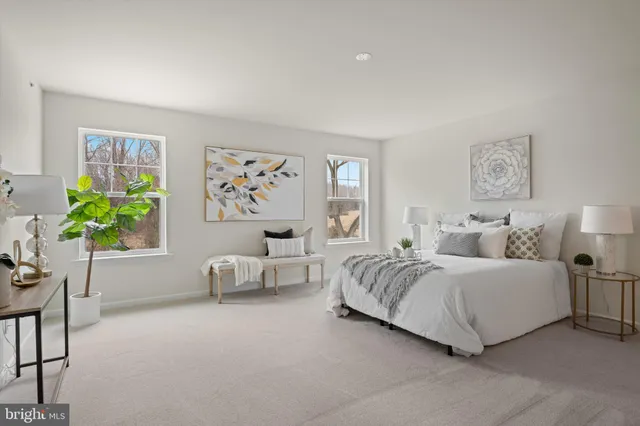 a large kitchen with kitchen island a sink a center island stainless steel appliances and a large window