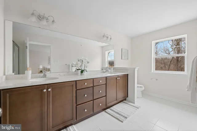 a spacious bedroom with a bed and a window