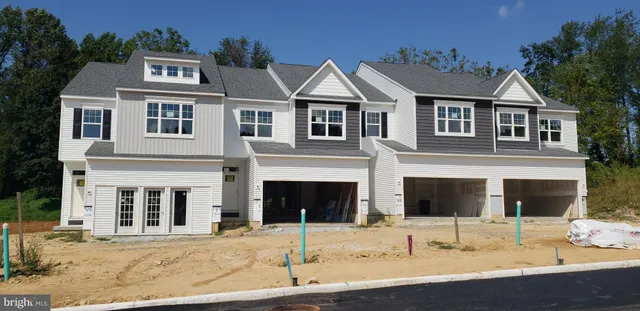 a view of a white house with large windows