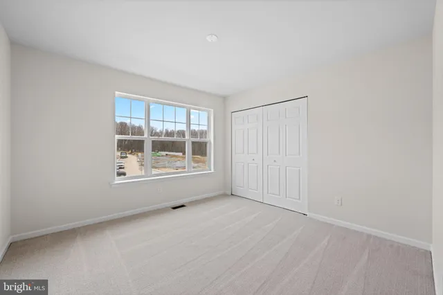 a bedroom with a large bed and a closet
