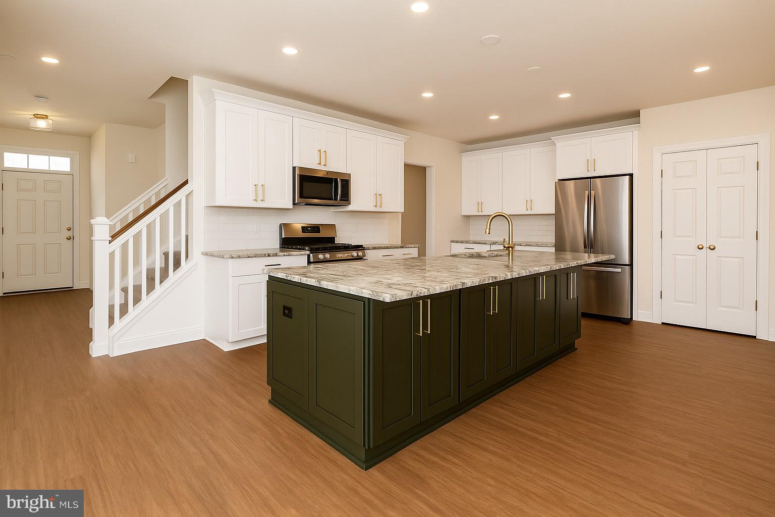 5 Tullow Hill Drive Kennett Square, PA 19348 - Photo 4 of 40 a kitchen with stainless steel appliances granite countertop a stove a sink and a refrigerator