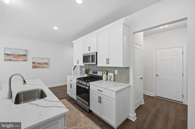a kitchen that has a sink and a stove in it