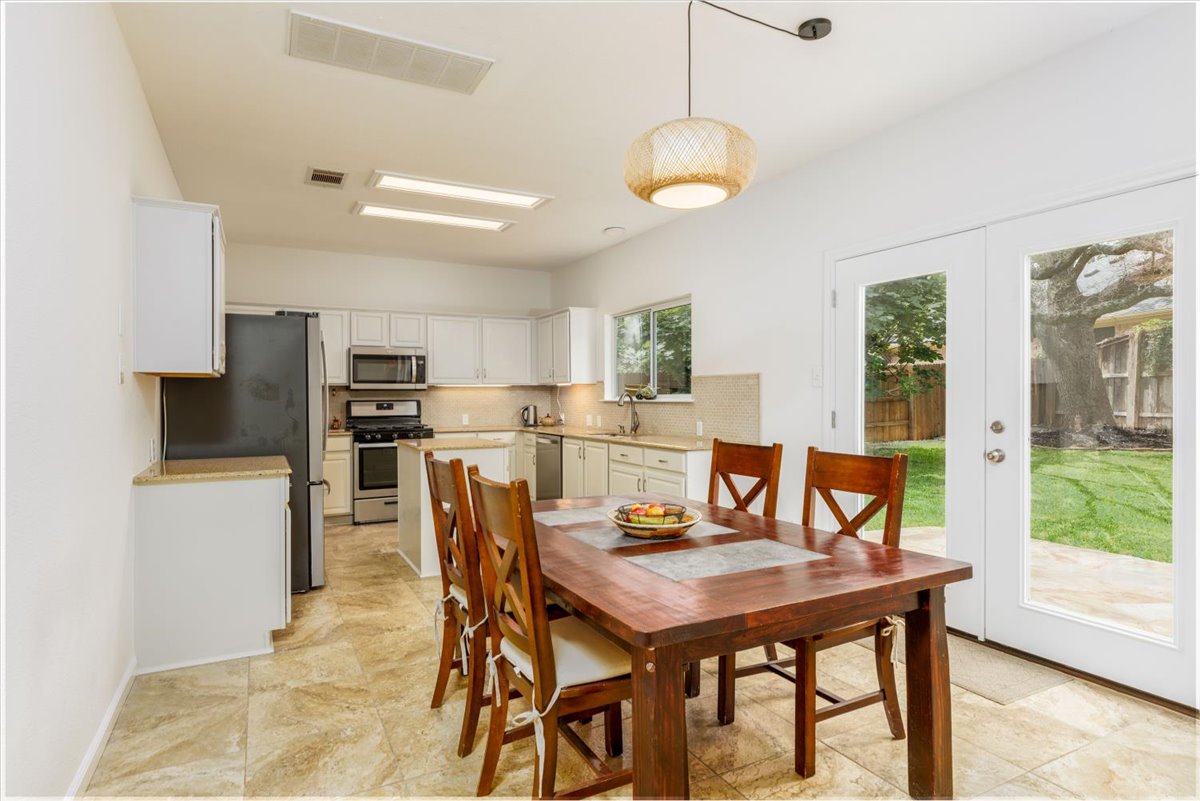 7136 Ridge Oak Road Austin, TX 78749 - Photo 10 of 28 Functional kitchen with ample cabinetry and dining space that opens to the backyard.