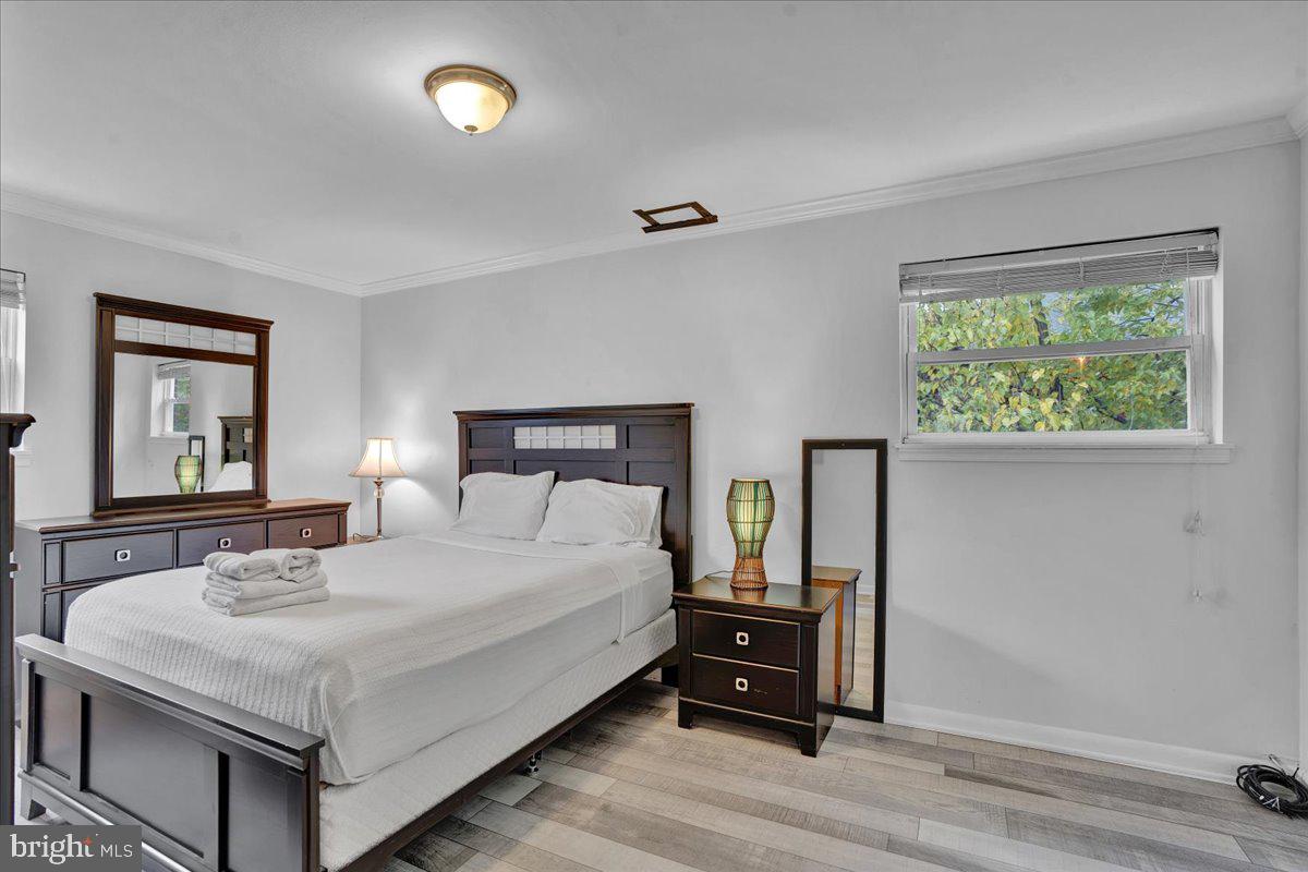 1952 Goodnaw Street, Unit 2 Philadelphia, PA 19115 - Photo 12 of 26 a bedroom with a bed and a dresser