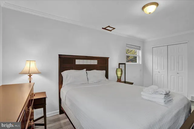 a bedroom with a bed and a lamp