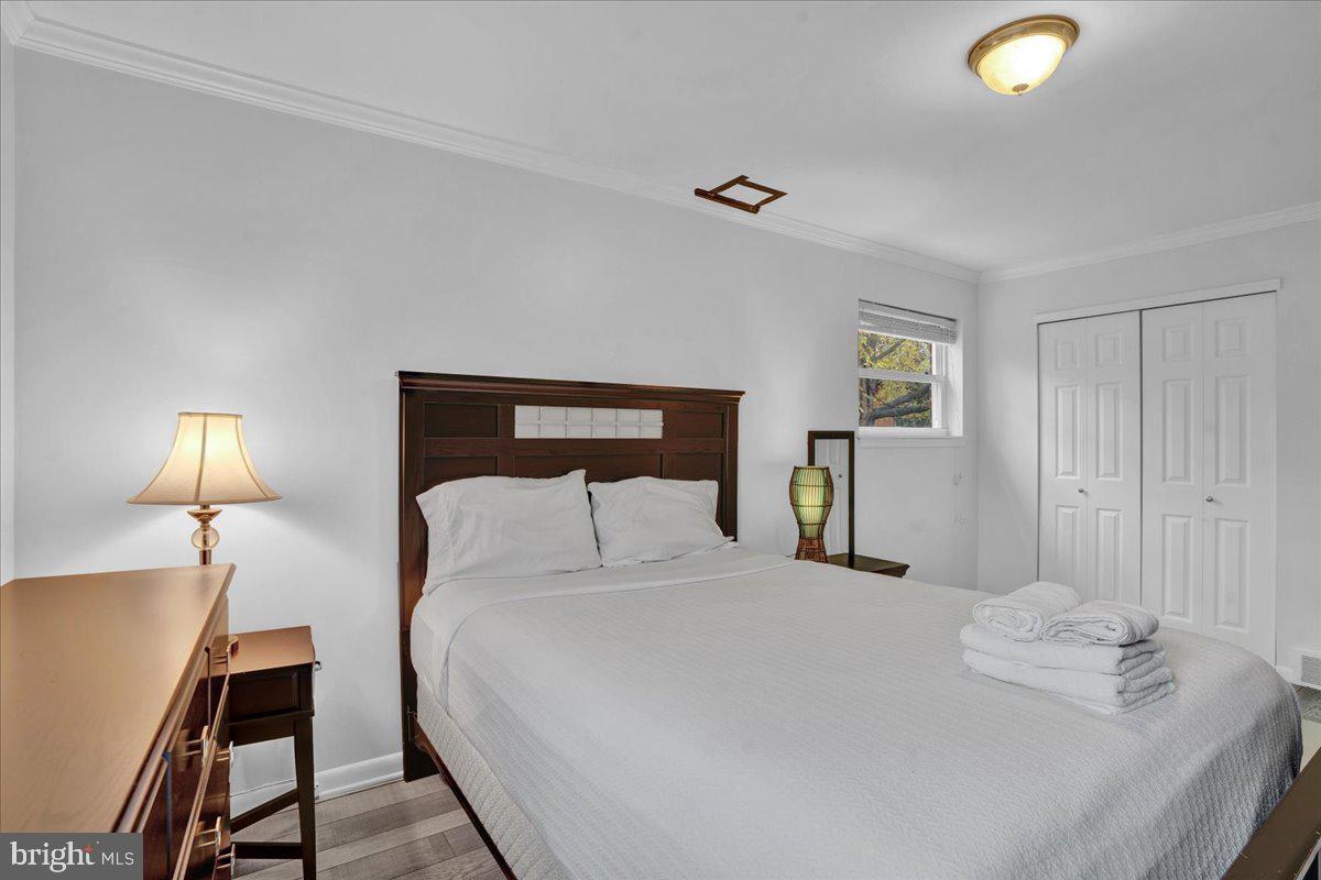 1952 Goodnaw Street, Unit 2 Philadelphia, PA 19115 - Photo 14 of 26 a bedroom with a bed and a lamp