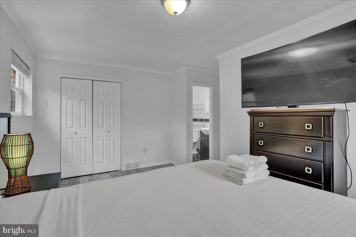 1952 Goodnaw Street, Unit 2 Philadelphia, PA 19115 - Photo 15 of 26 a bedroom with a bed and a television