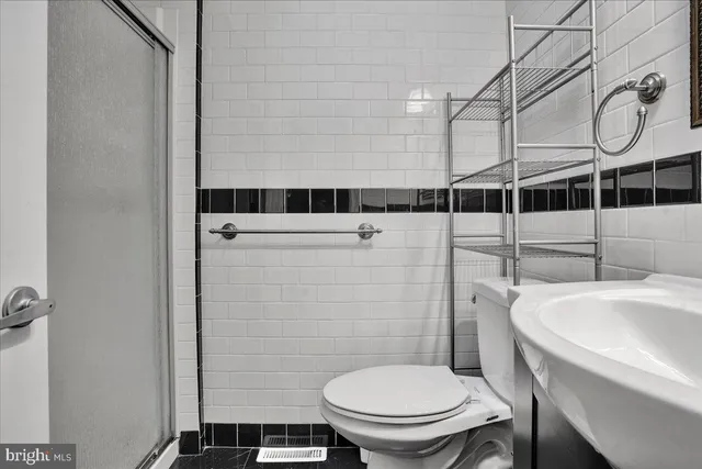 a white toilet sitting next to a bathroom sink