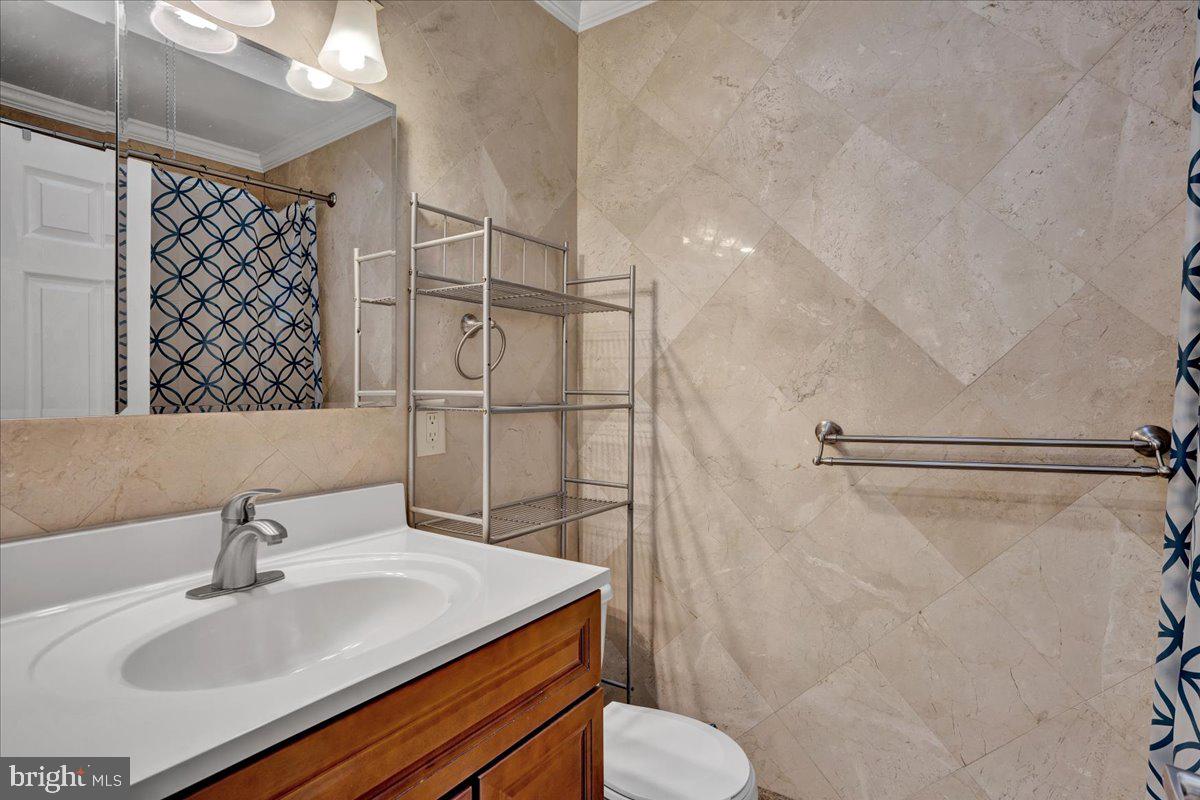 1952 Goodnaw Street, Unit 2 Philadelphia, PA 19115 - Photo 18 of 26 a bathroom with a sink toilet and shower