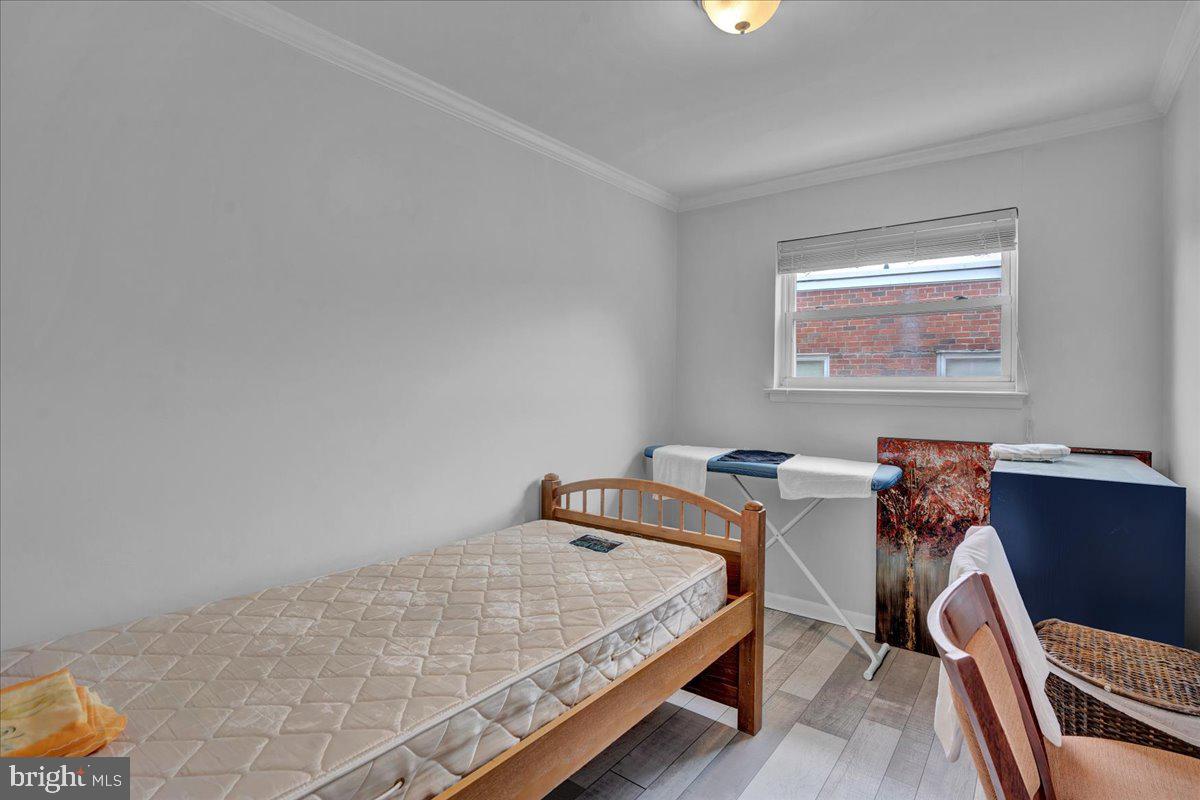 1952 Goodnaw Street, Unit 2 Philadelphia, PA 19115 - Photo 19 of 26 a bed sitting in a bedroom next to a window