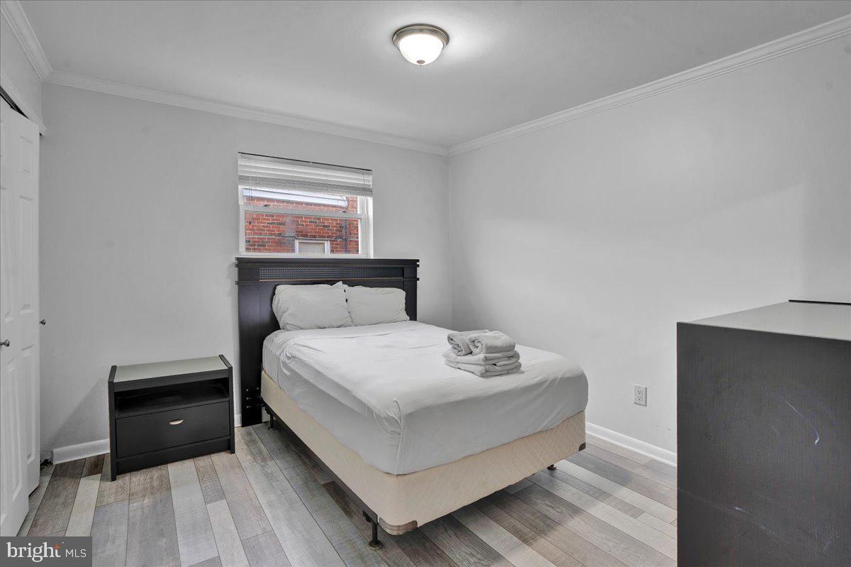 1952 Goodnaw Street, Unit 2 Philadelphia, PA 19115 - Photo 20 of 26 a bedroom with a bed and a window