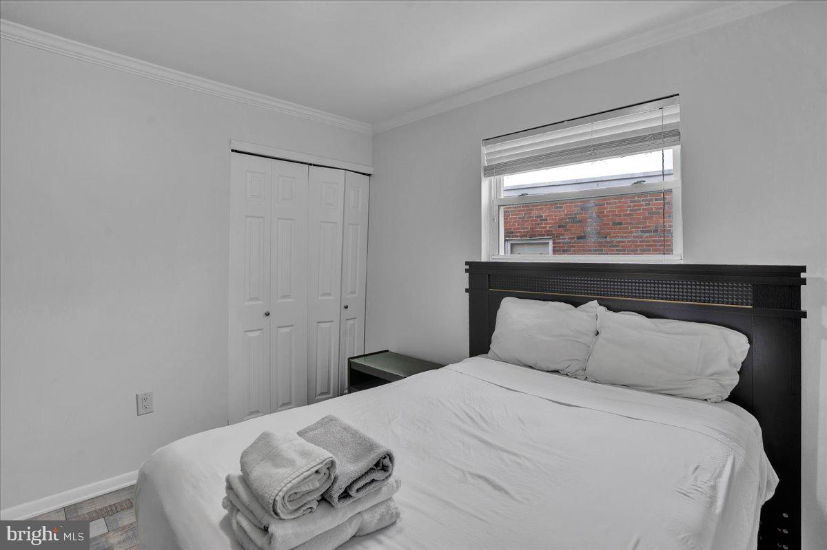 1952 Goodnaw Street, Unit 2 Philadelphia, PA 19115 - Photo 21 of 26 a bedroom with a bed and a window